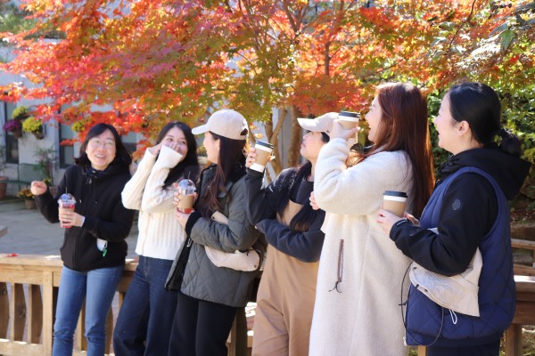 단풍나무 아래에서 환하게 웃는 직원들의 모습