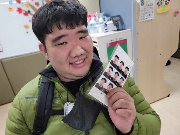 증명사진과 함께 사진찍는 이용자