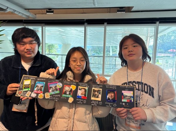 가족구성원이 함께 오전에 찍은 사진을 꾸면서 하나의 앨범을 만든 것을 자랑하고 있는 모습