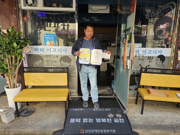 후원증서를 들고 사진을 찍고 있는 모습